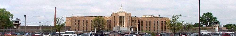 The current front of Auburn Prison. Note the two guard towers on either side and Copper John on top