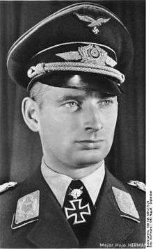 Black-and-white portrait of a man wearing a military uniform with an Iron Cross displayed at his neck.