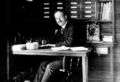 Photograph of George Ellery Hale at work at his desk.