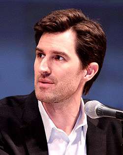 Joseph Kosinski in front of a microphone during a press conference.