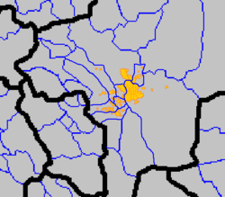 Map of the metroplolitan area with provincial bordars in black, county borders in blue, and cities with orange borders and yellow background