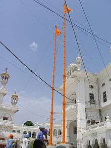 Nishan Sahib flags on tall poles over Harmandir Sahib in India