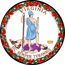 A circular seal with the words "Virginia" on the top and "Sic Semper Tyrannis" on the bottom. In the center, a woman wearing a blue toga and Athenian helmet stands on the chest of dead man wearing a purple breastplate and skirt. The woman holds a spear and sheathed sword. The man holds a broken chain while his crown lies away from the figures. Orange leaves encircle the seal.