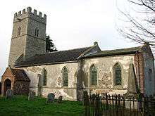 A church in stone, partly rendered, seen from the southeast, showing the battlemented tower, the south porch, and the nave and chancel, both with lancet windows