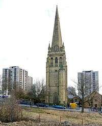 A tower with a stair turret, pinnacles and a spire