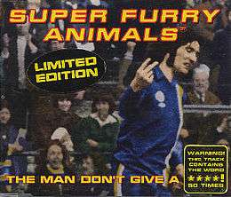 A dark-haired man in blue, white and yellow football kit scowls as he turns to his left, holding the index and middle fingers up on his right hand, his palm facing inwards. The hand points to an out-of-image figure, but appears to be pointing to the viewer. "Super Furry Animals" is rendered in yellow and red text across the top, while along the bottom the single's title is partially given: "The Man Don't Give a ****". The final word is obscured by a sticker, which itself claims that the word is used 50 times during the song